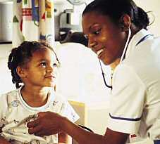 Nurse listening to a young girl's heart beat.