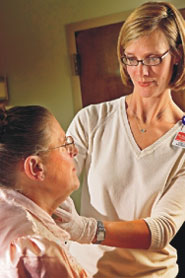 Nurse helps a man in a rehabilitation session. 