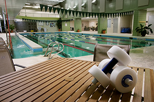 Picture of womens hand weights beside a swimming pool in the welness center.